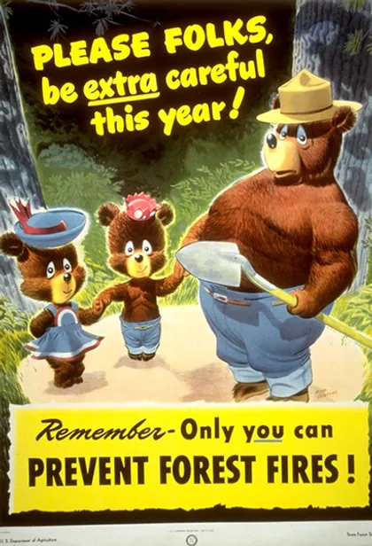 Cartel de Smokey y dos ositos tomados de la mano donde se lee: "¡Por favor amigos, tengan más cuidado este año!".
